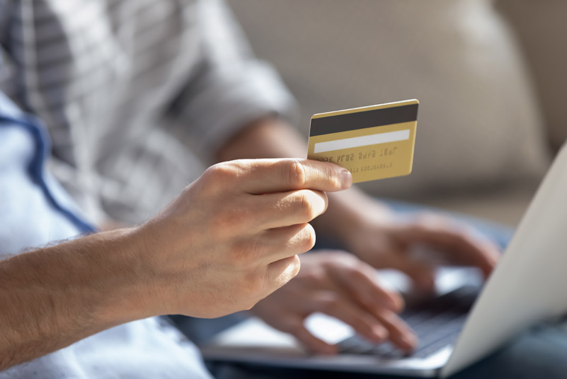 Nice person inputting credit card info into laptop
