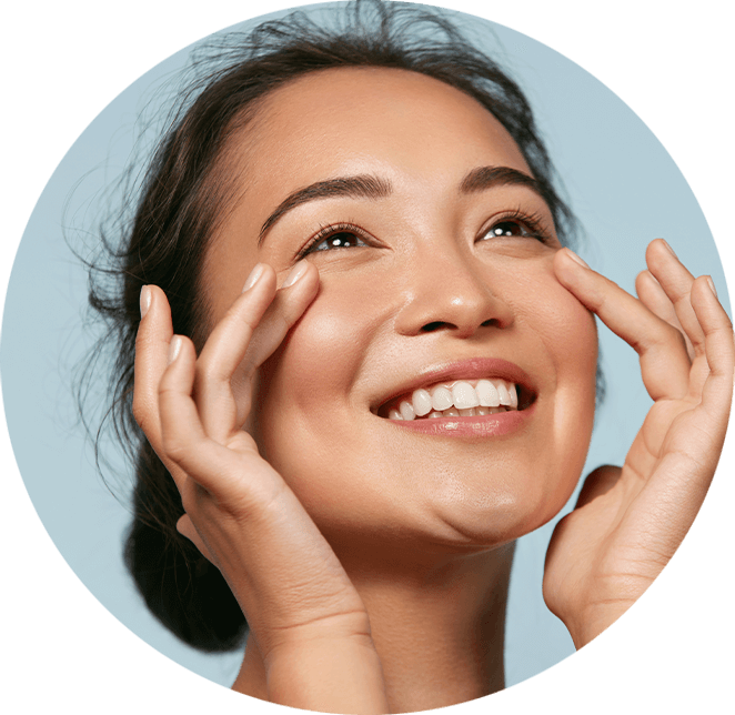 Very nice lady with dark hair smiling while touching her face