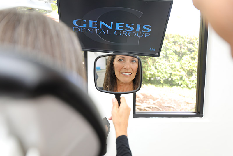 Patient looking into a mirror smiling
